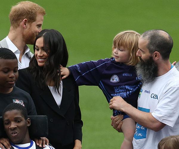 A cheeky toddler pulls Meghan Markle’s hair and Prince Harry can’t stop laughing