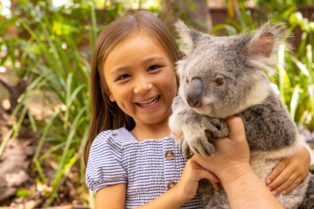 Girl cuddling a koala