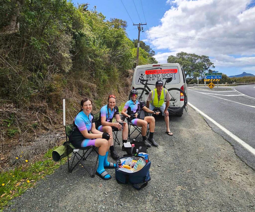 Hannah and her team have set up picnic chairs on the side of the road for a lunch break.