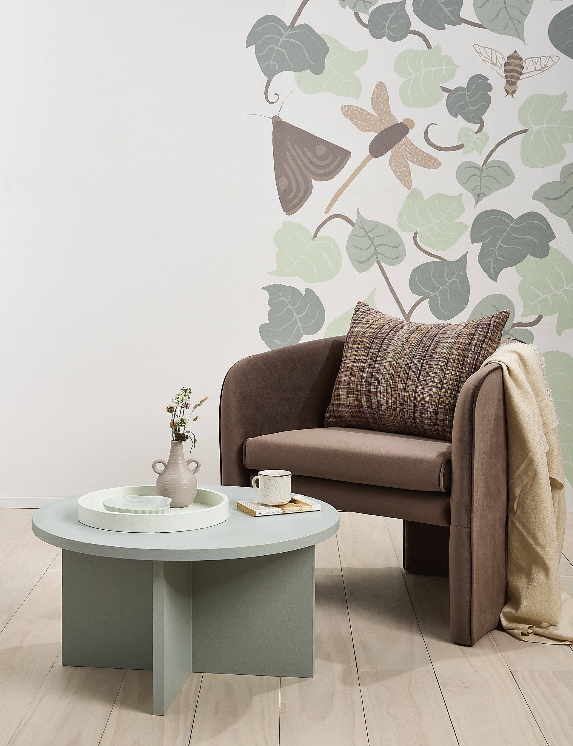 Brown chair, green coffee table, mural wall using eco-friendly paint