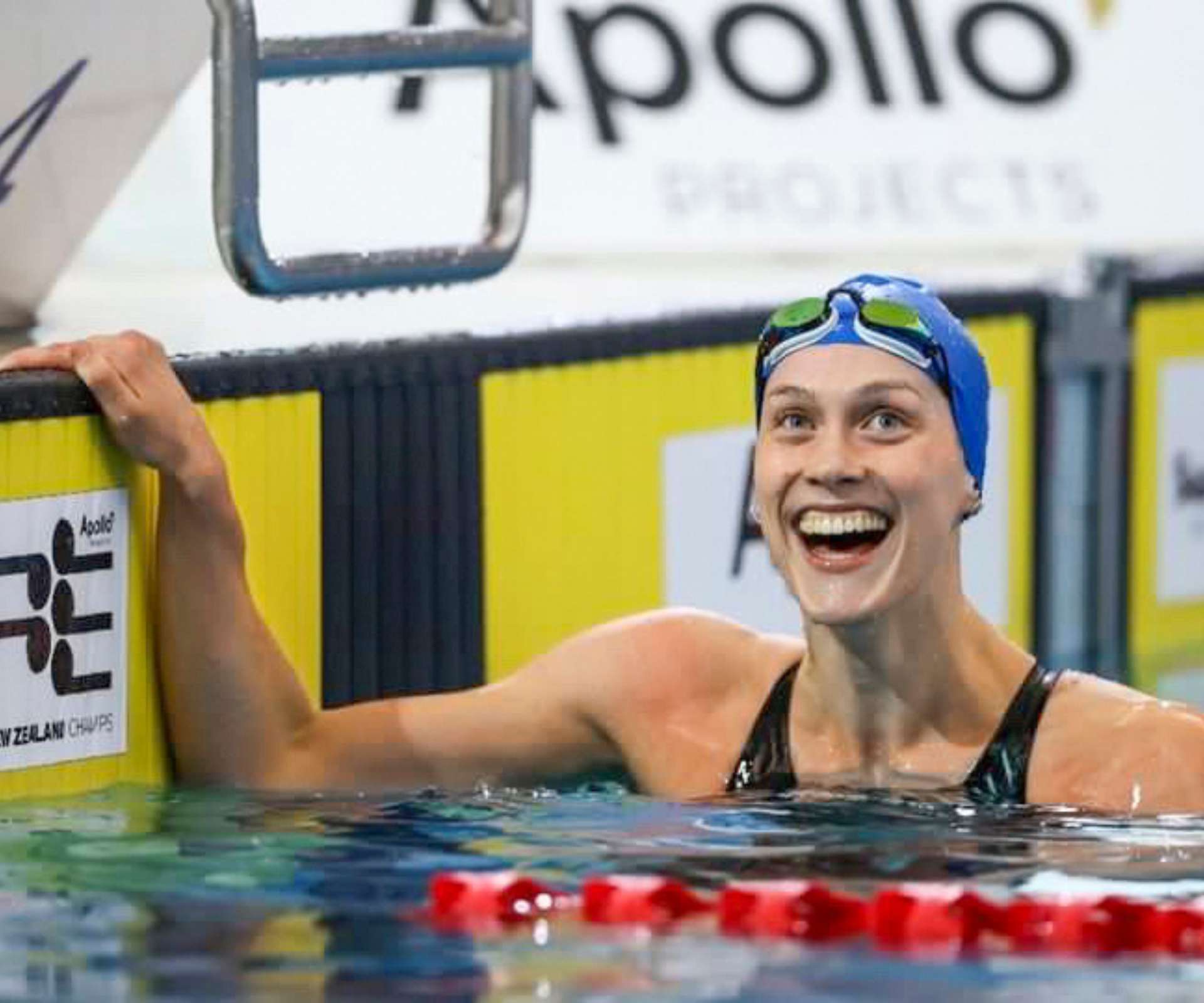 Hazel smiling in the pool at the end of a race