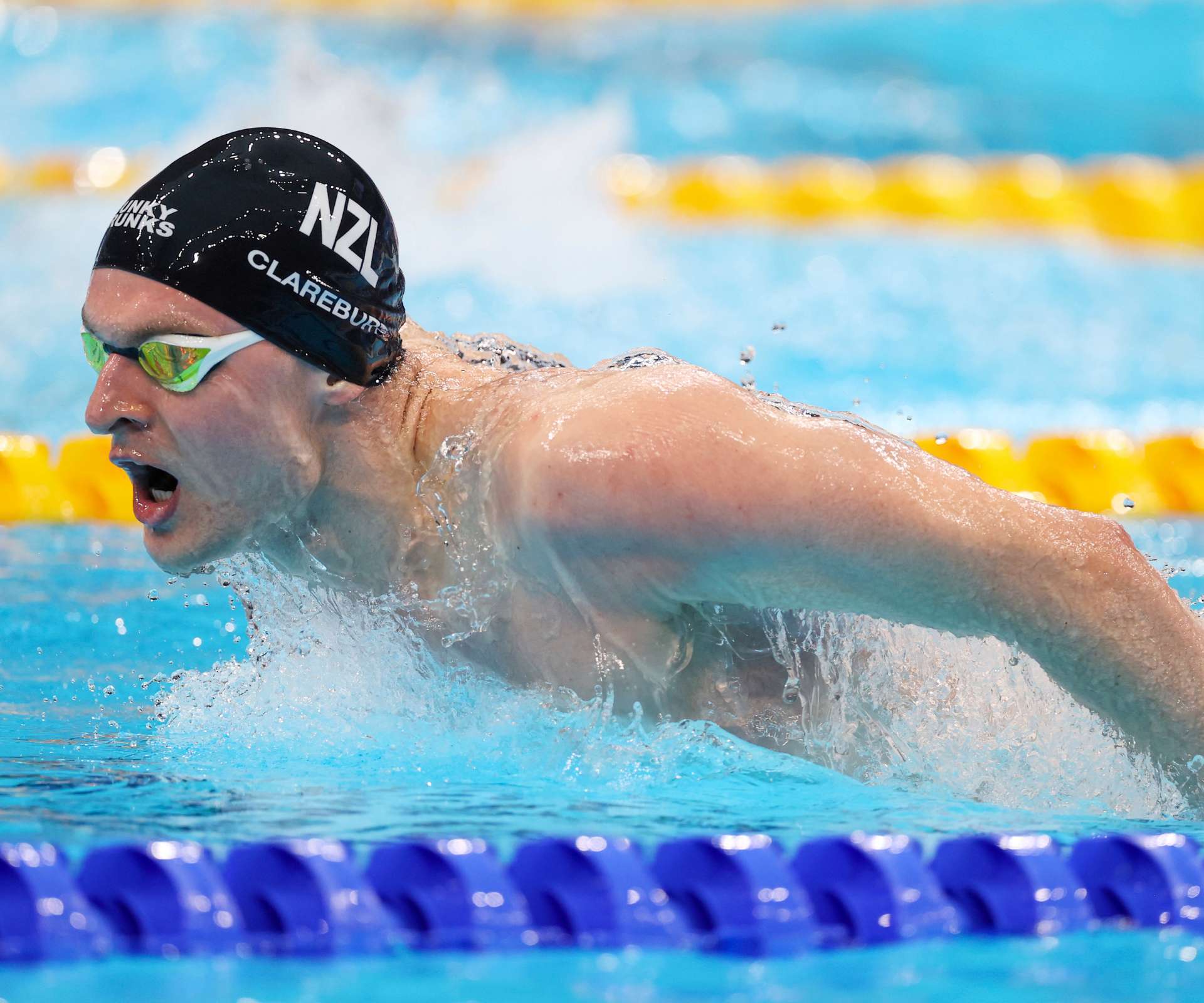 Lewis breaking the water's surface while competing
