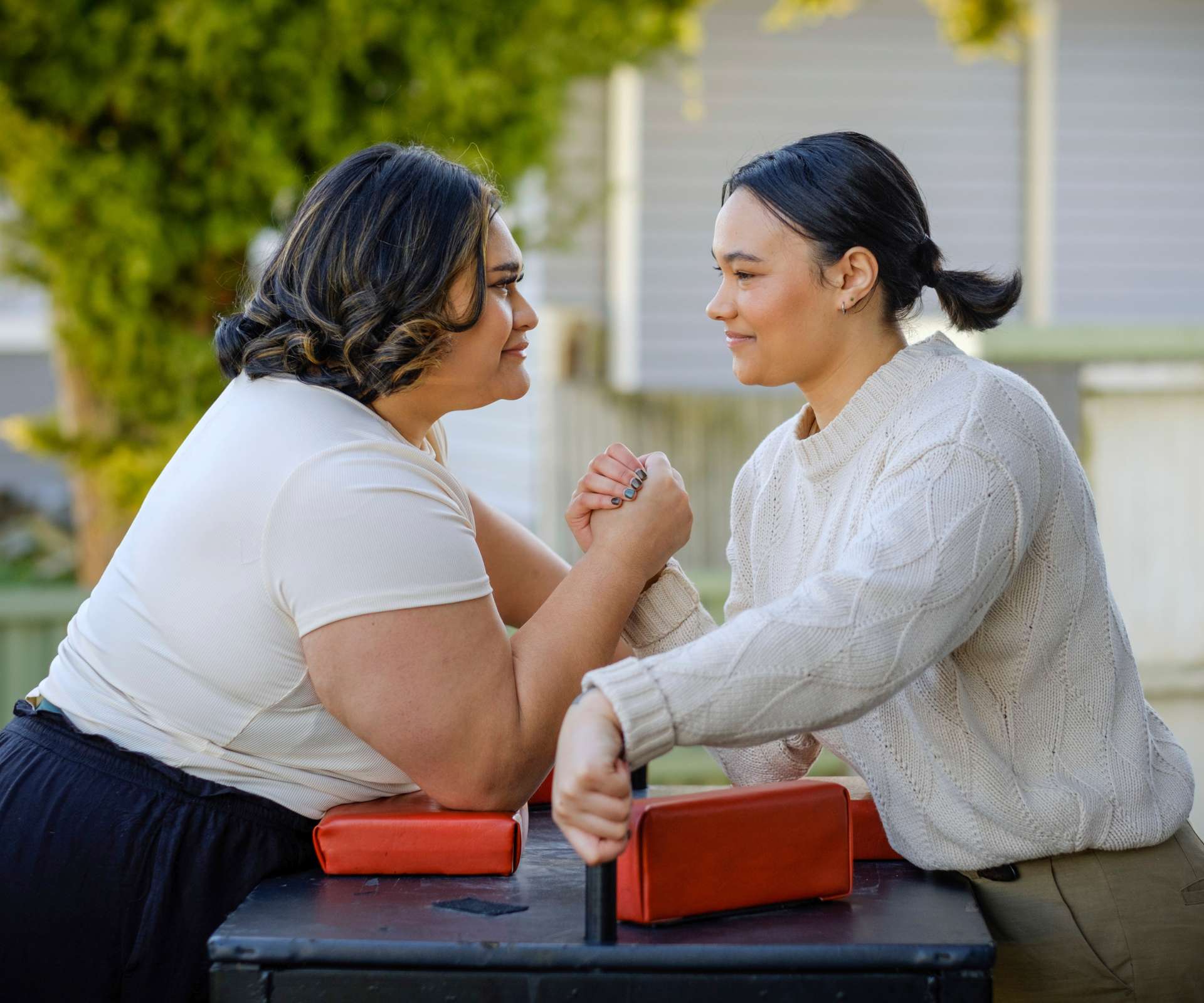 Dariah and Ashleigh eyeing each other down before an arm wrestle