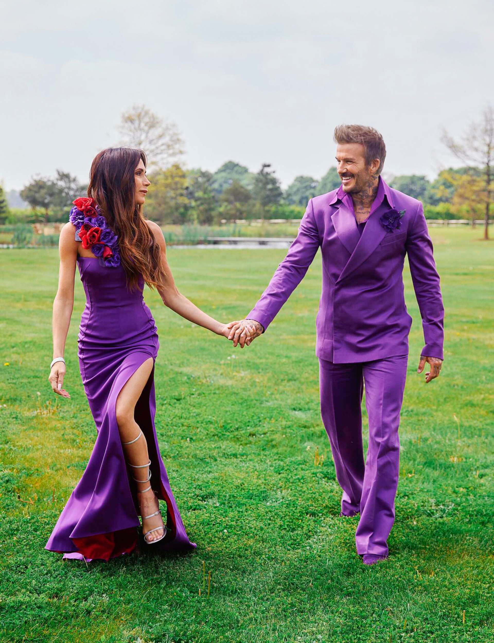 In their infamous purple wedding outfits walking through a field to honour their 25 year wedding anniversary