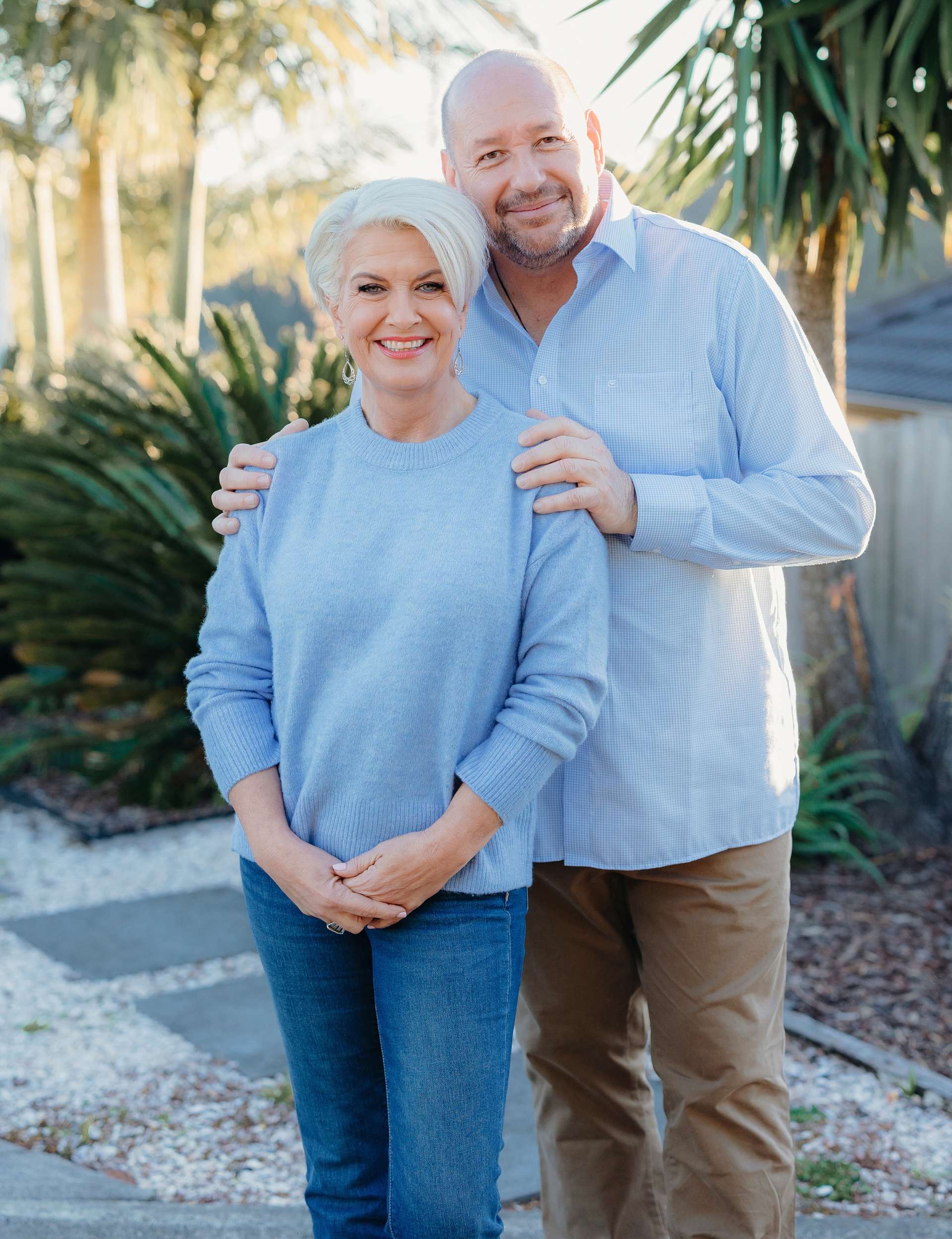 Mike standing behind Lorna with his hands on her shoulders