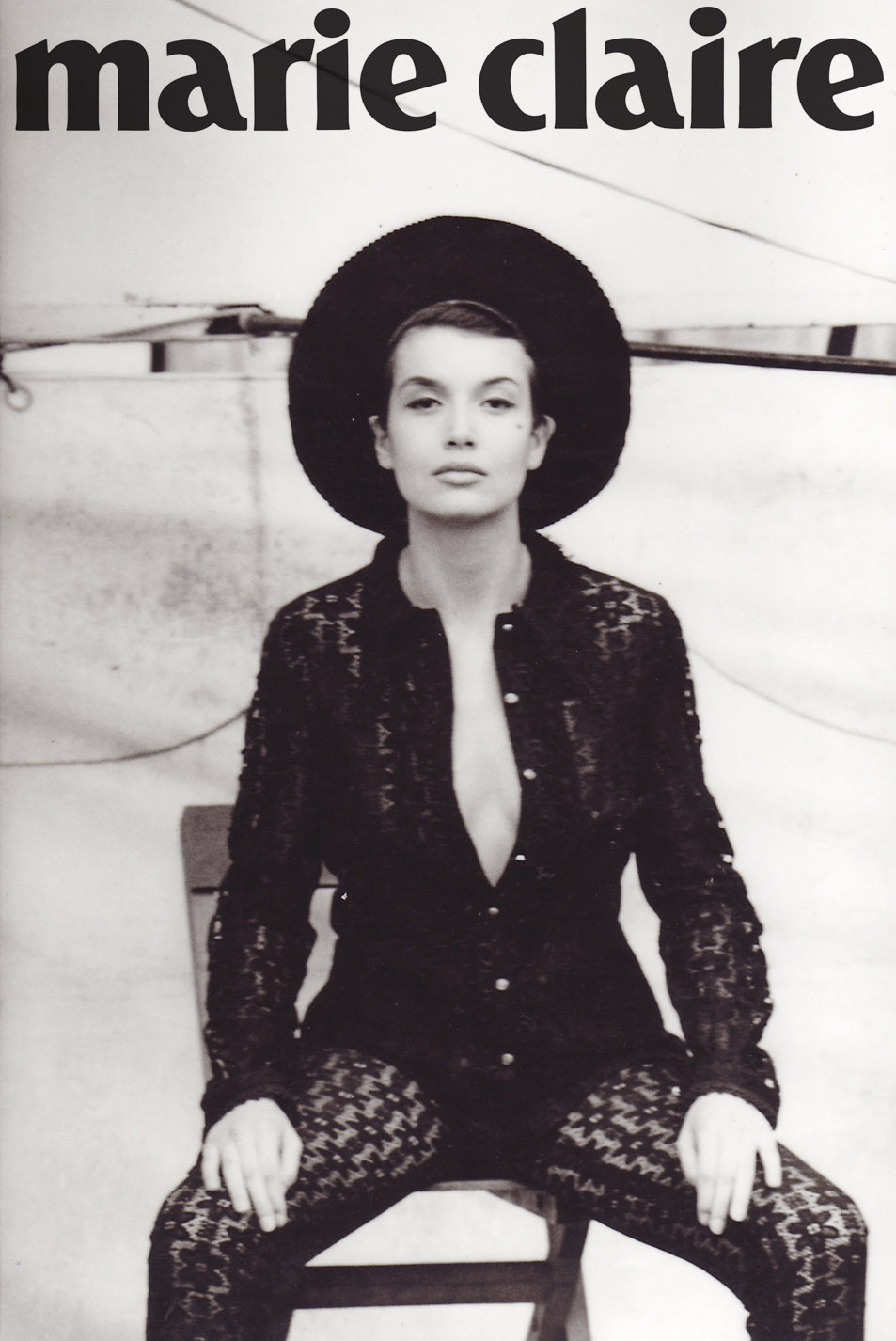 black and white magazine cover of model in black lace jumpsuit