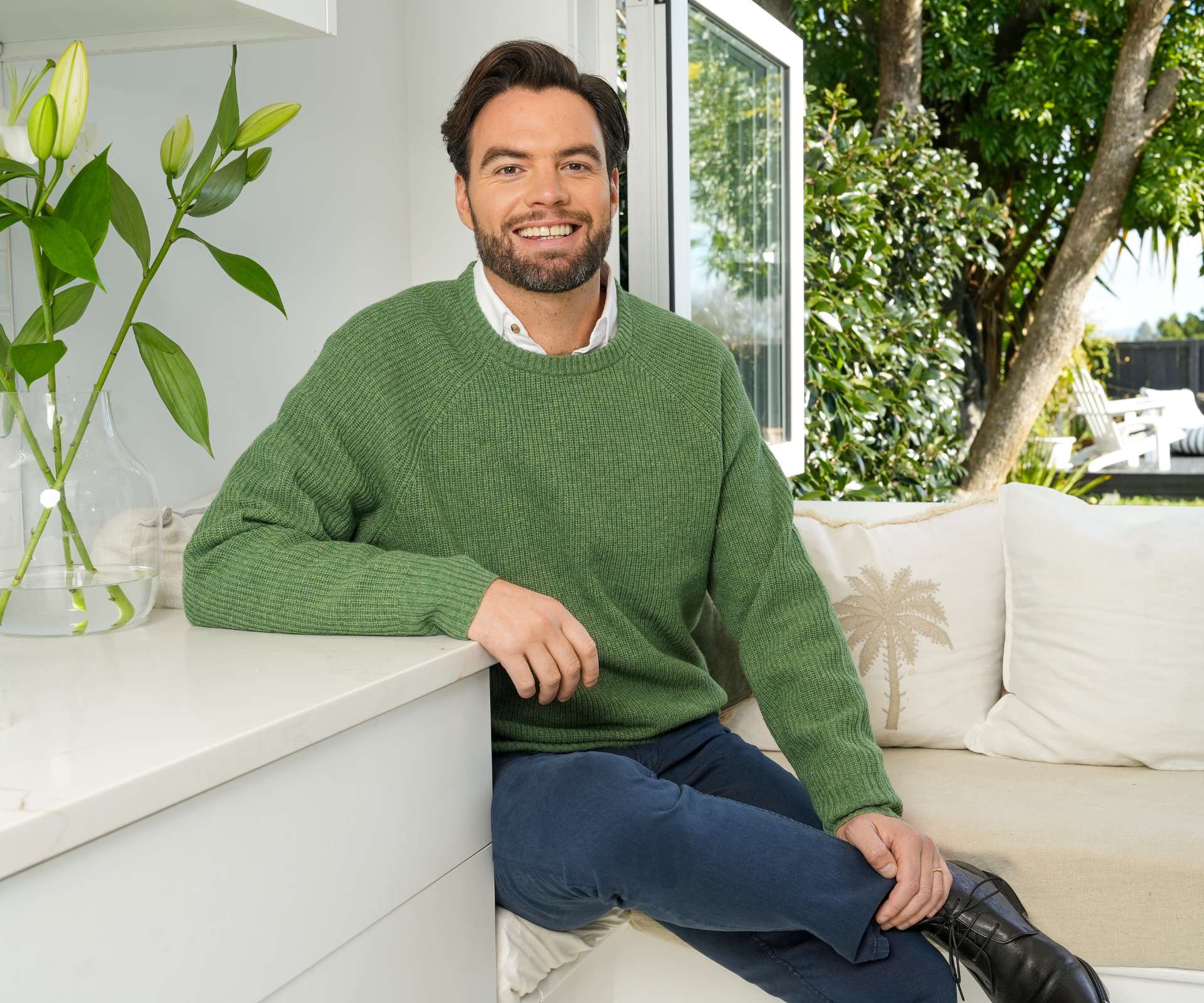 Ryan leaning on the corner of his kitchen counter