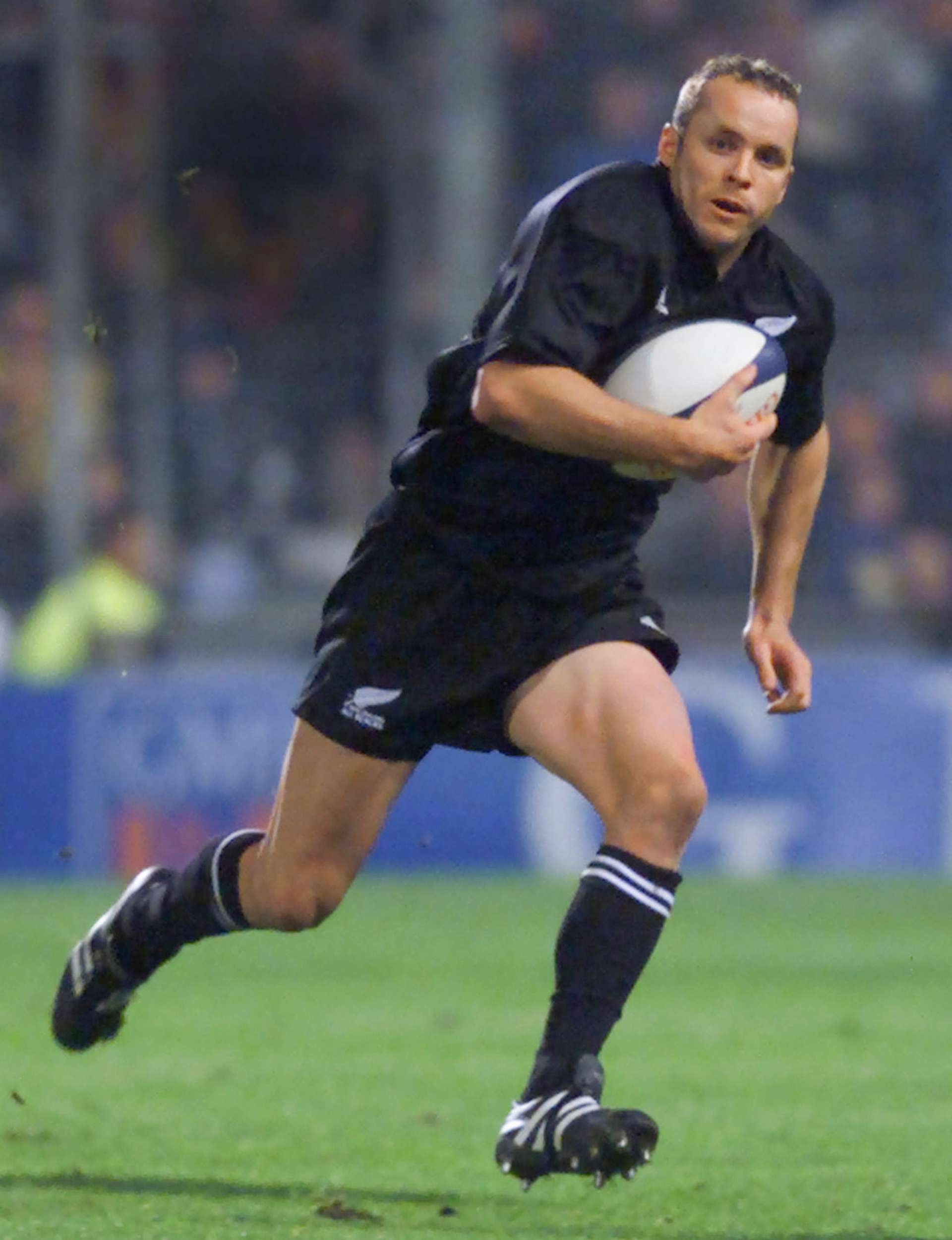 Christian in action with the ball for the All Blacks