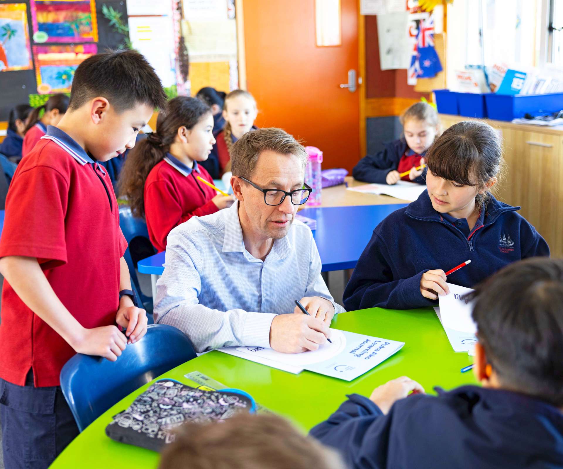 Sir Ashley Bloomfield working with a couple of students on the Pause Breathe Smile programme