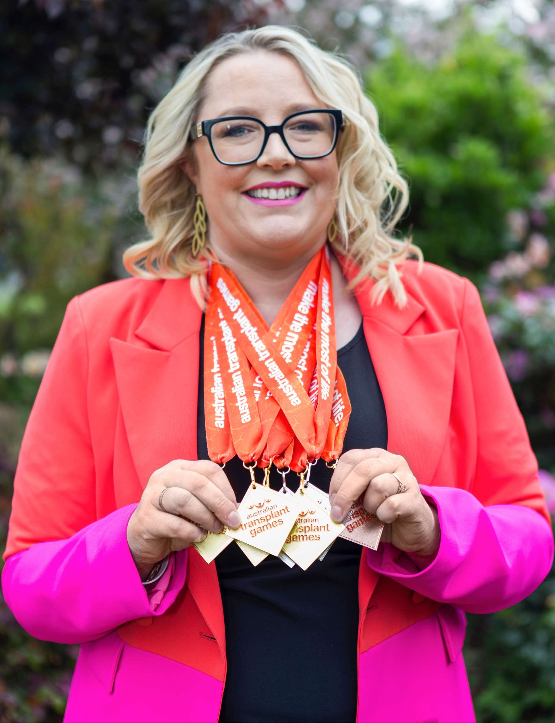 Jess holding up her medals