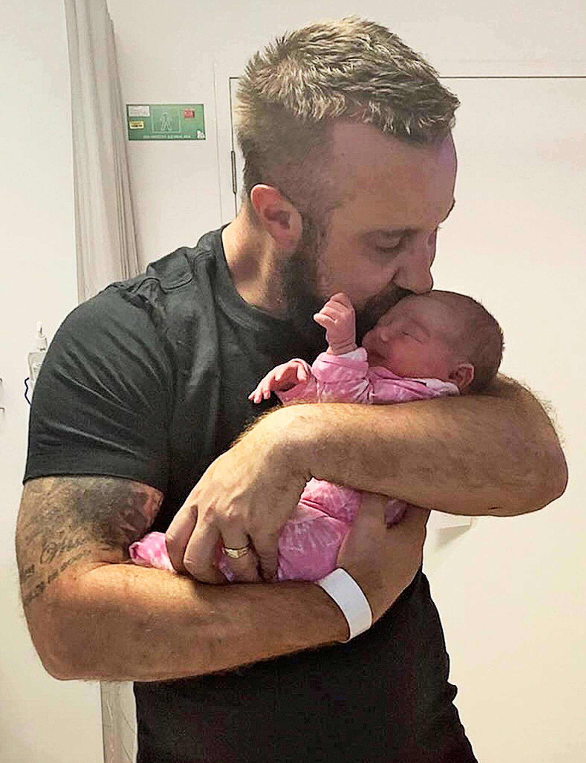 Haydn holding baby Matilda at the hospital