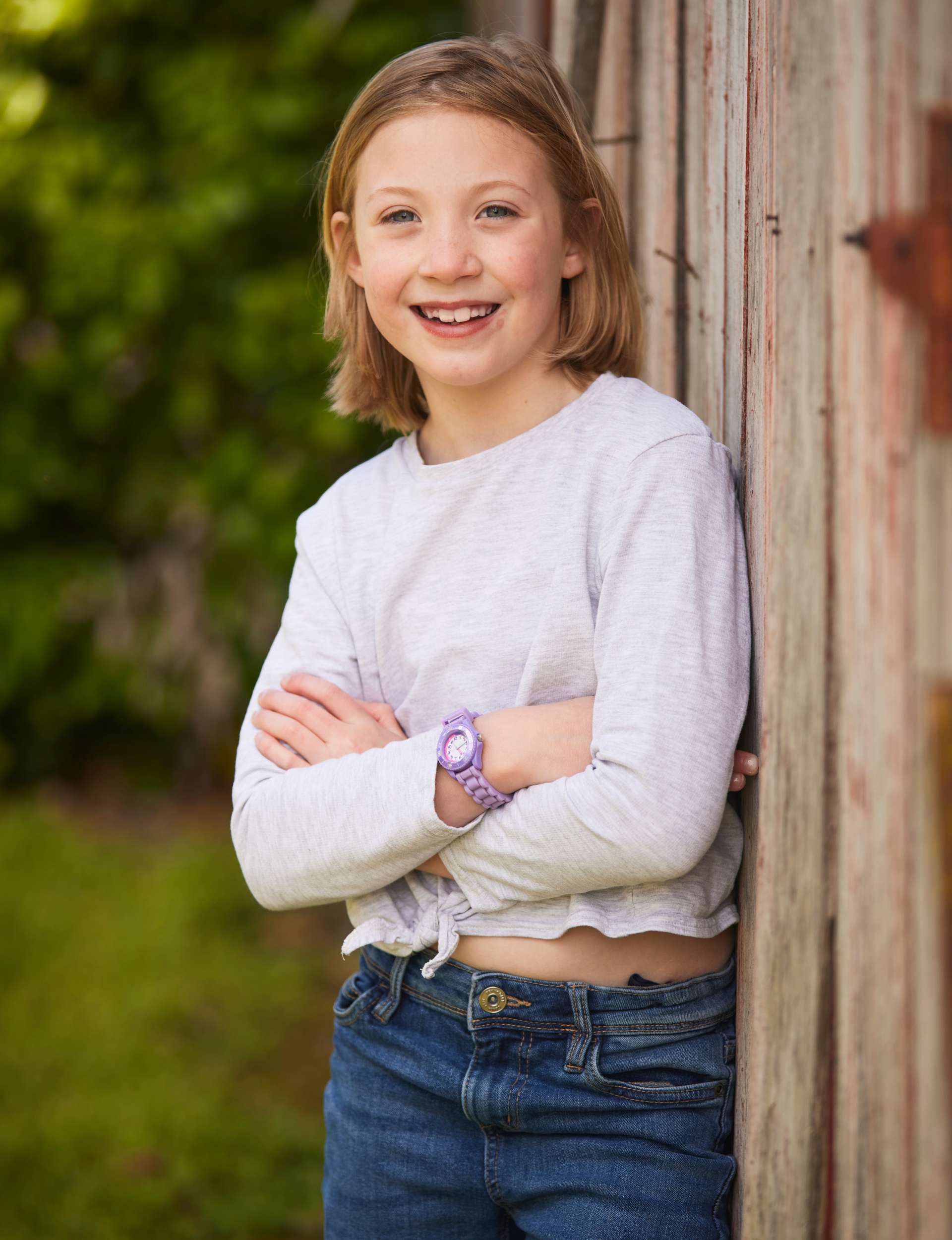 Isla leaning against a shed wall