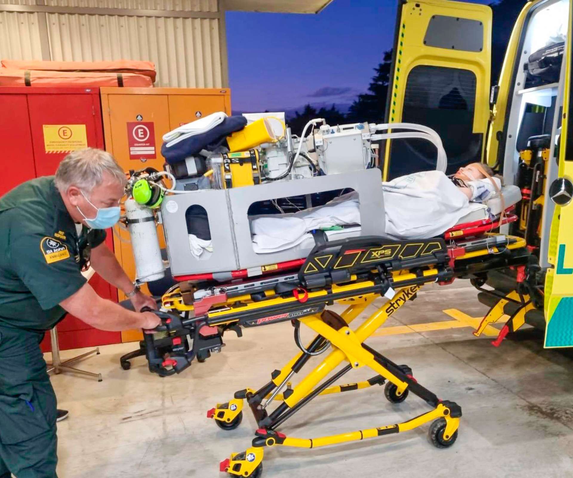 Isla van der Westhuizen being wheeled into the back of an ambulance