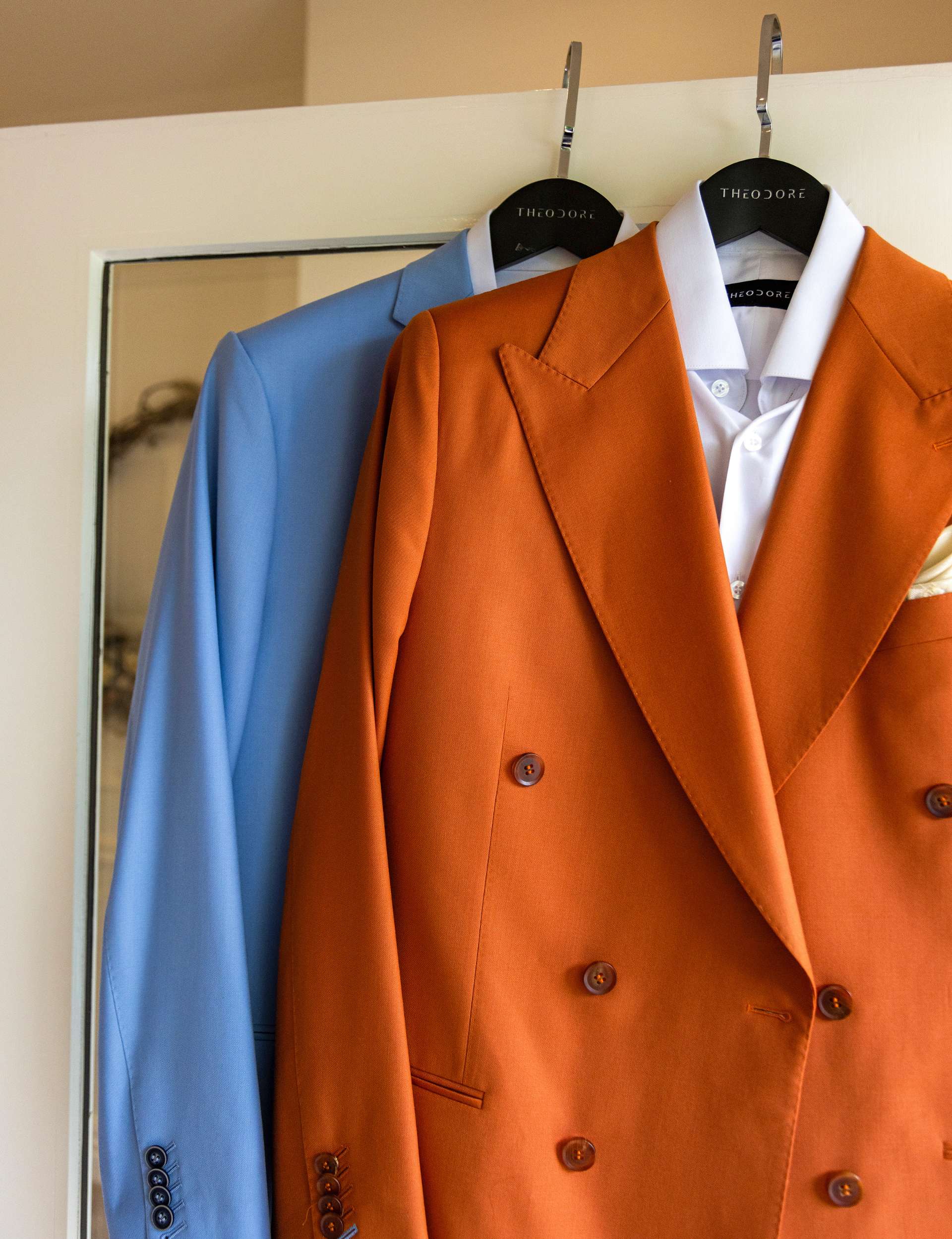 Jono and Josh's suits hanging on a door