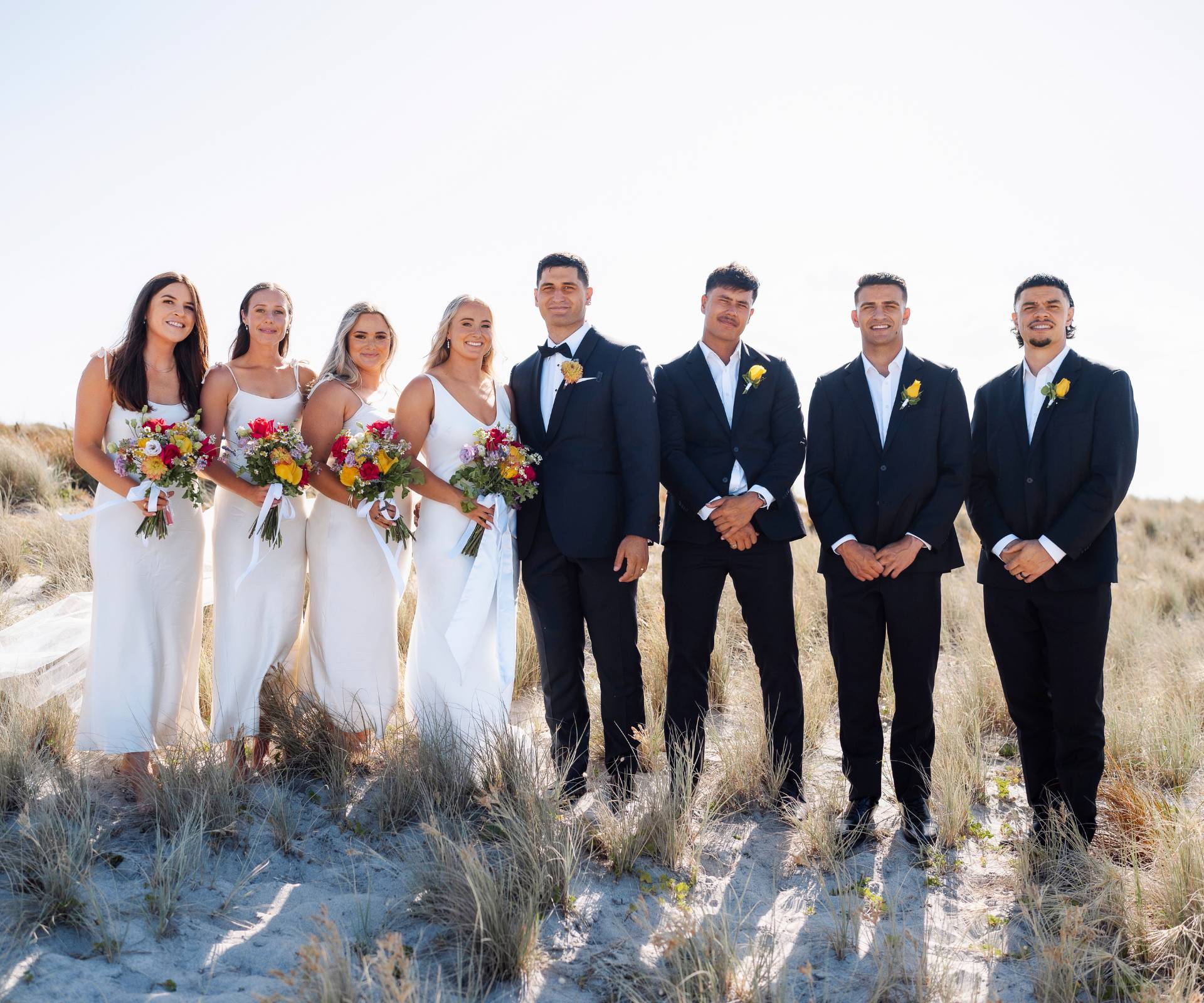 With their bridesmaids and groomsmen