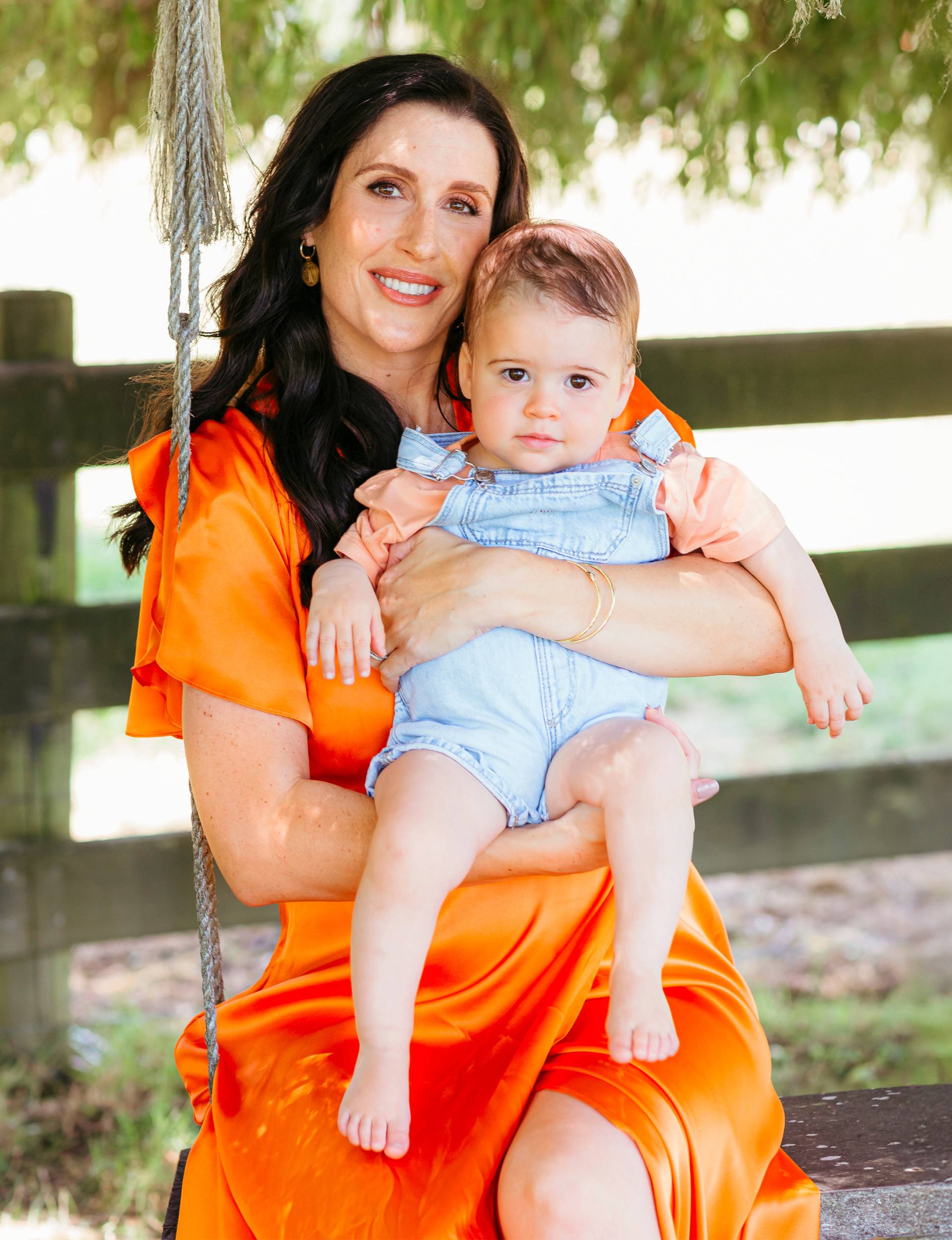 Nadine Higgins and Frankie on an outdoor swing