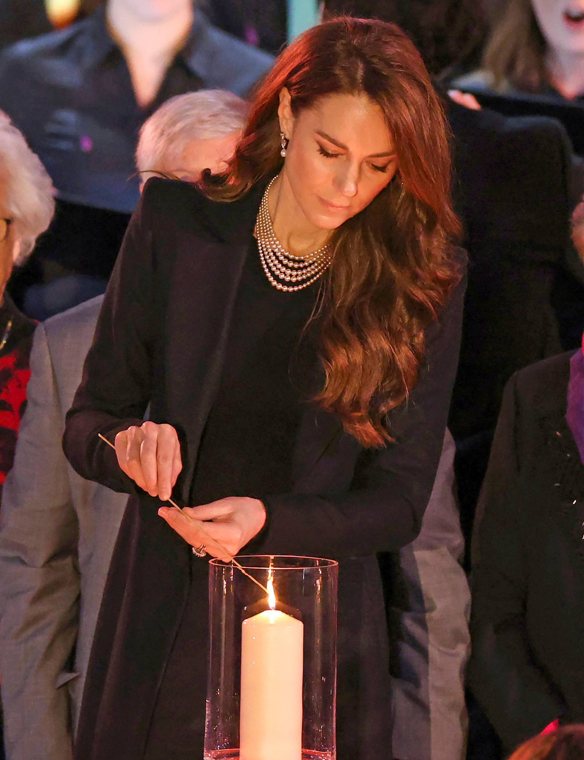 Princess Kate lighting a candle at a Holocaust ceremony