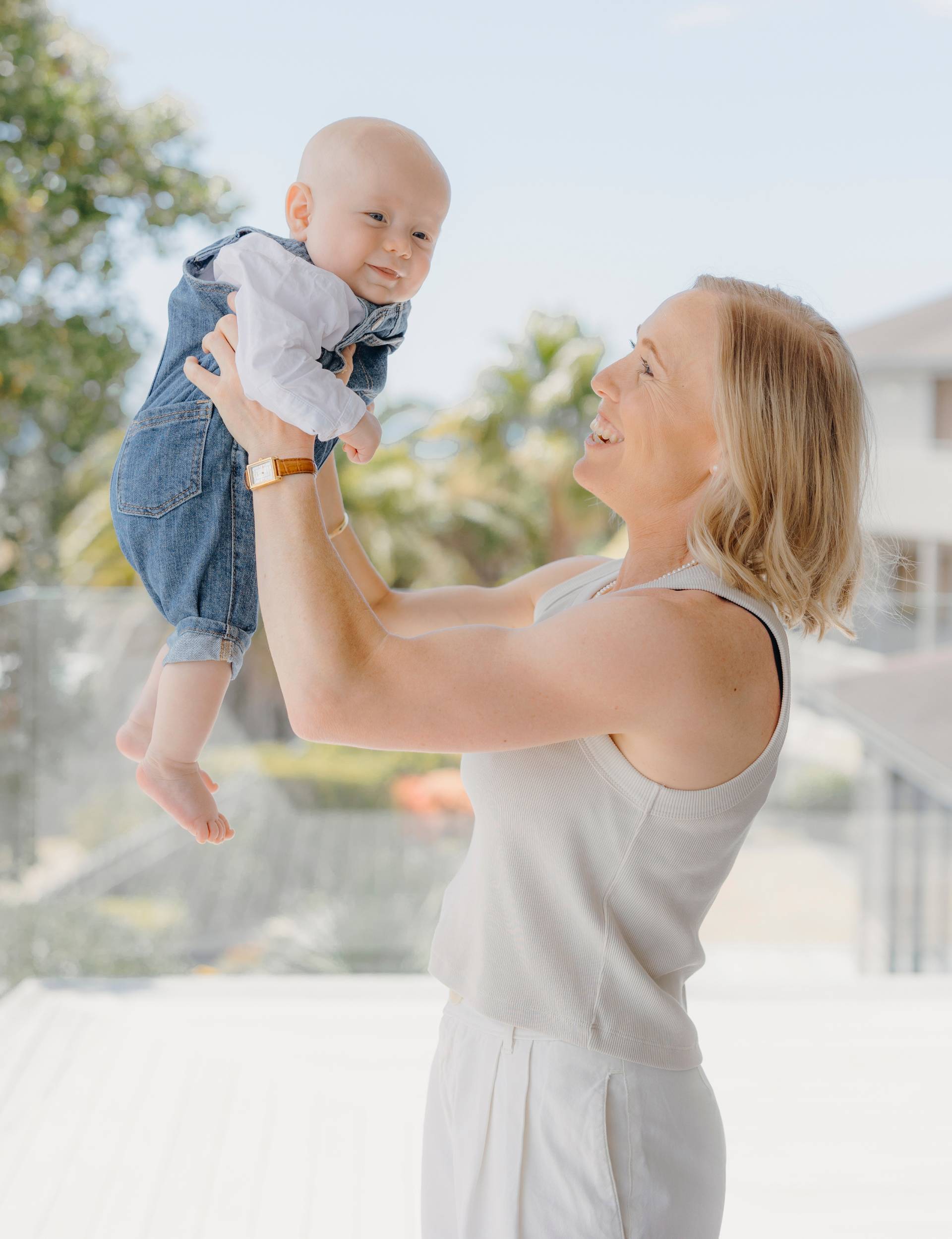 Betsy Hassett holding up baby N&oacute;i