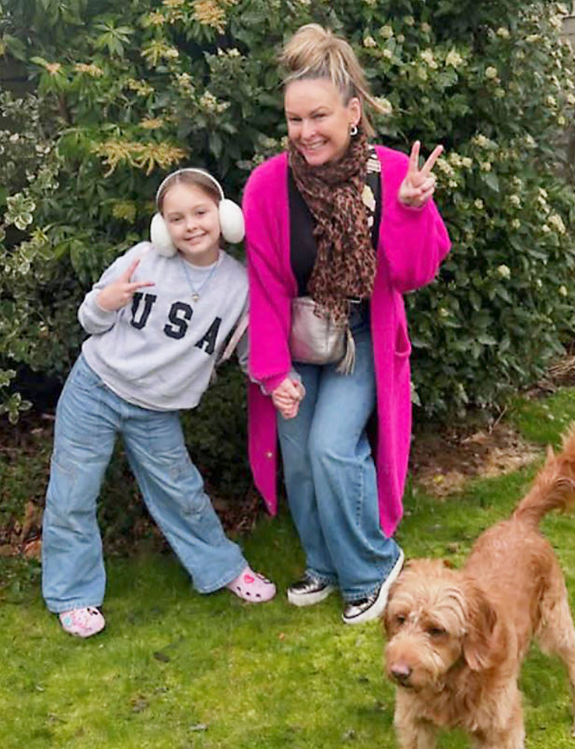 Mel with her daughter in their back yard