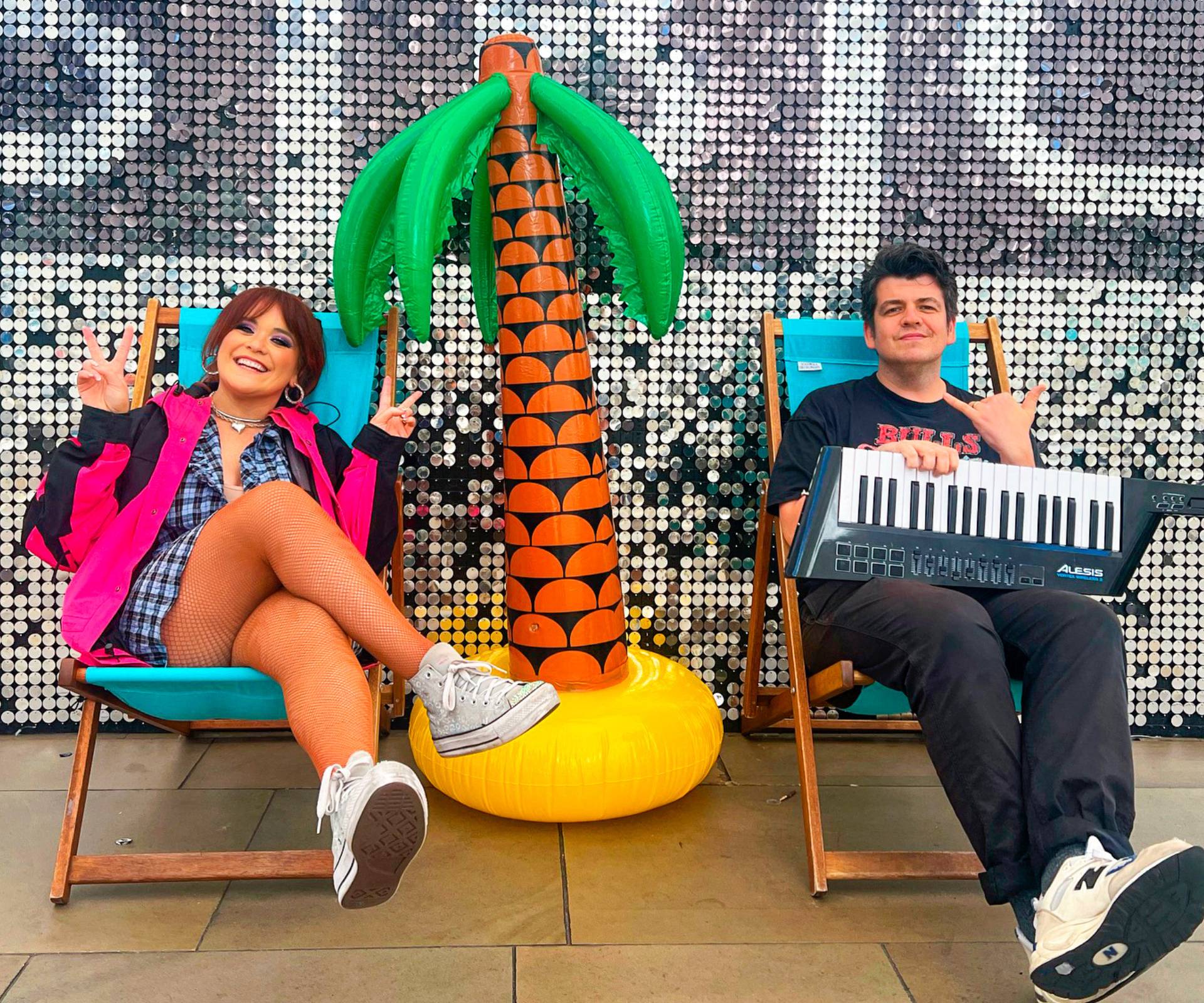 Laura Daniel sitting on a sun lounger with her husband