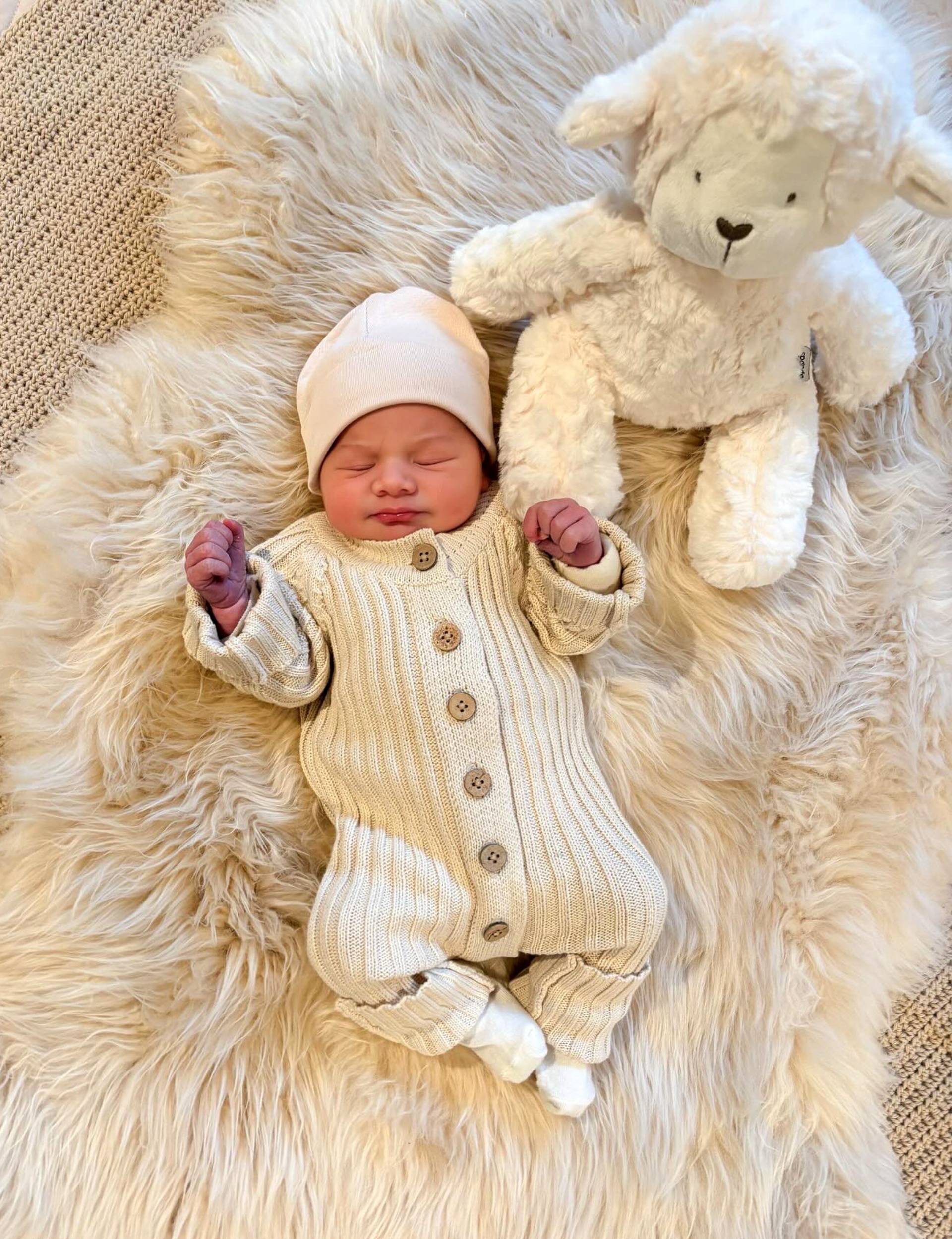 Jemma and Alvaro's baby girl laying on a fur rug