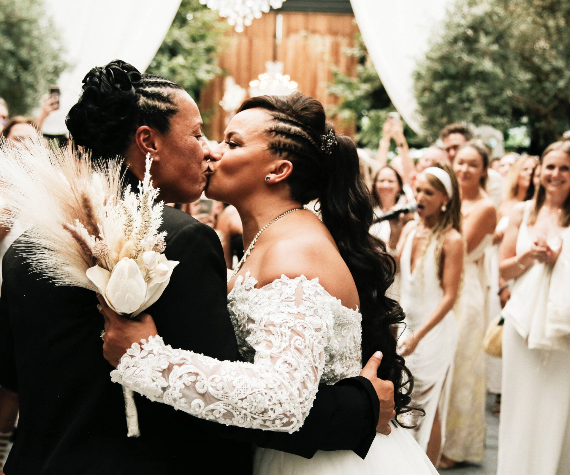 Natalie McDade and Megan Alatini kiss for their wedding guests