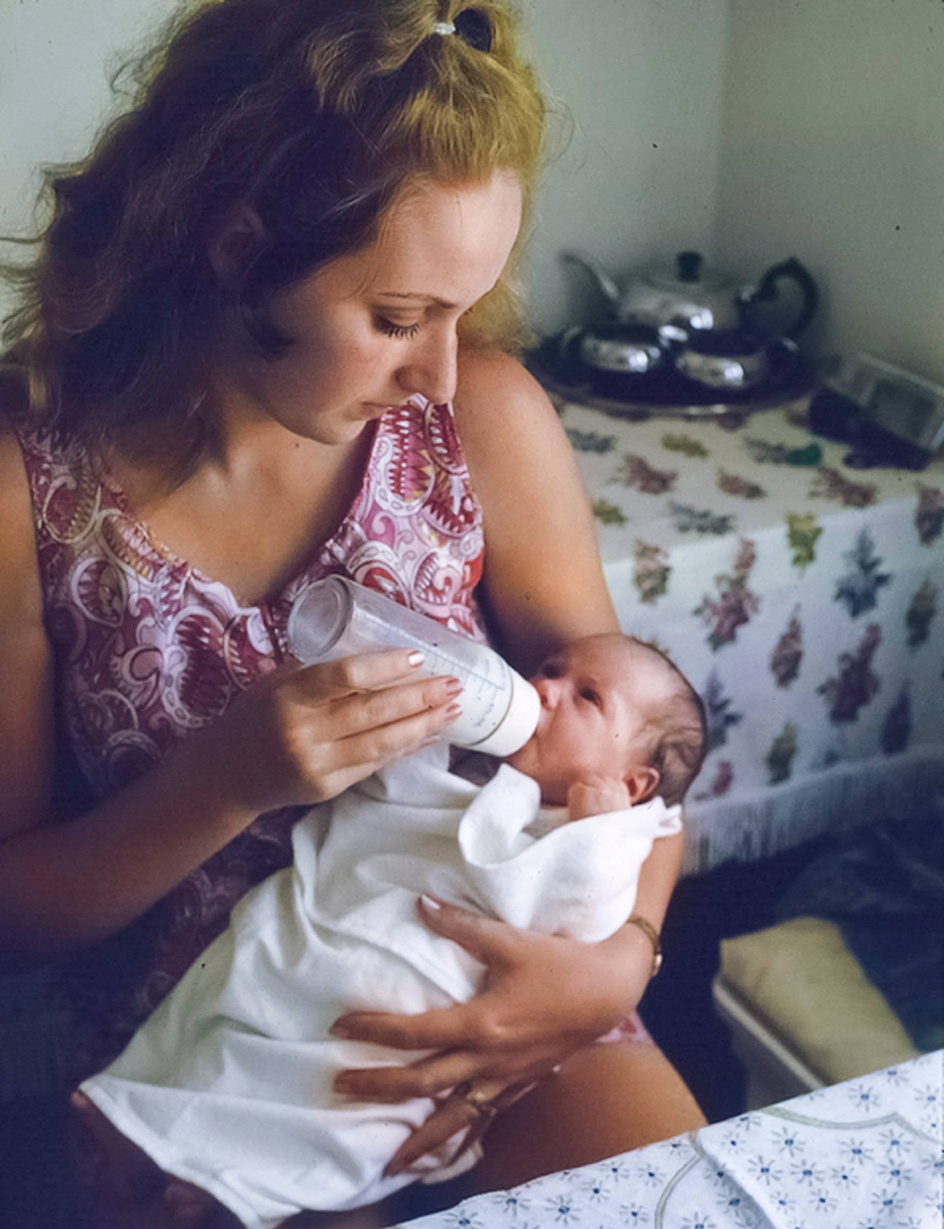 Fifteen-year-old Julia Hartley Moore bottle feeding her new born first daughter