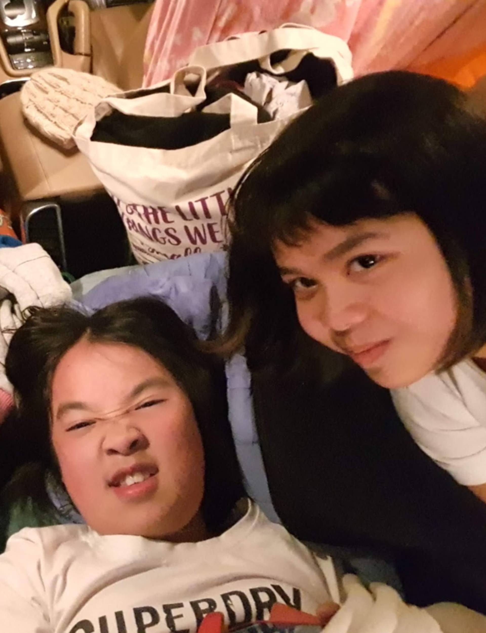 Alisa Pham and Vicky Ngo in their car filled with belongings