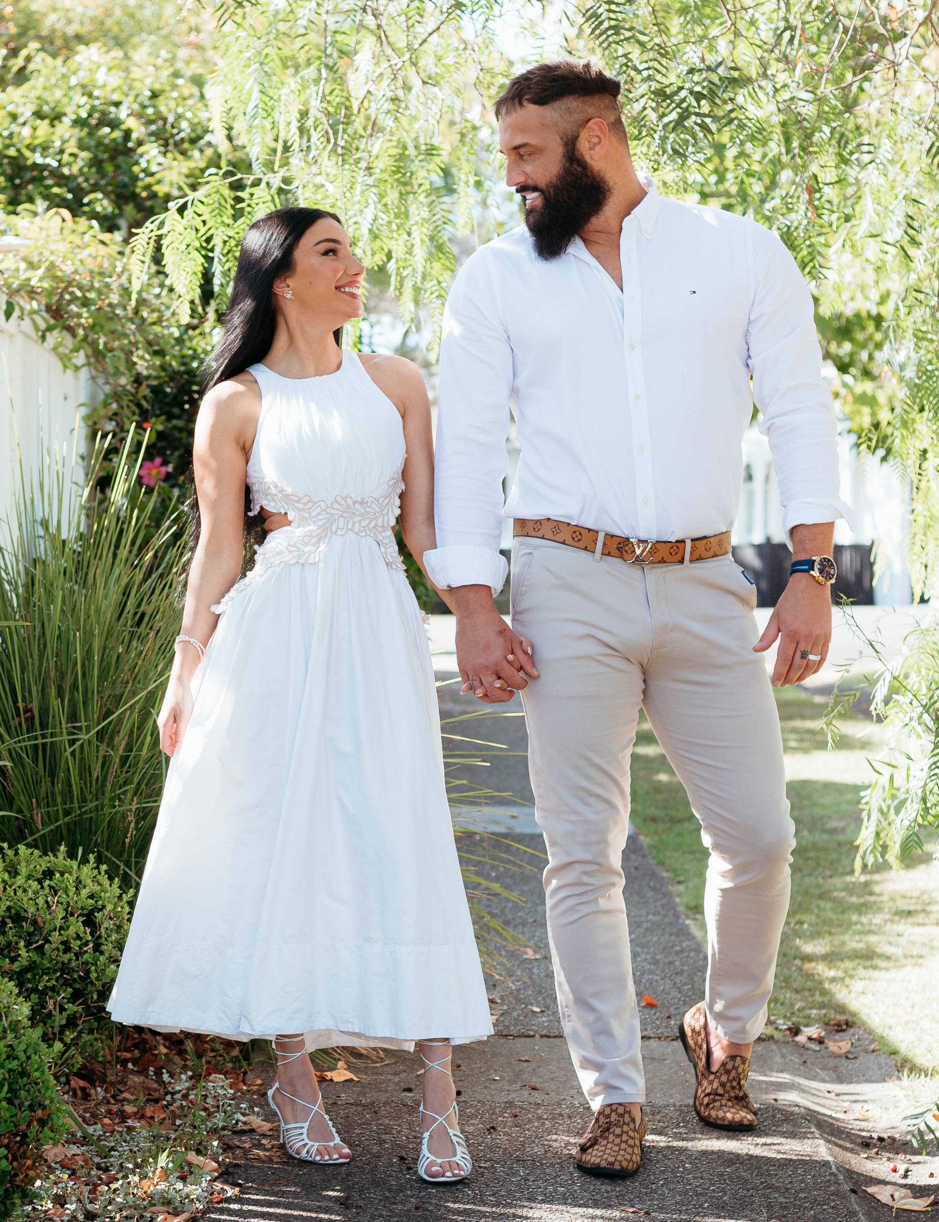 Naz and husband Jonny walking down a street hand-in-hand