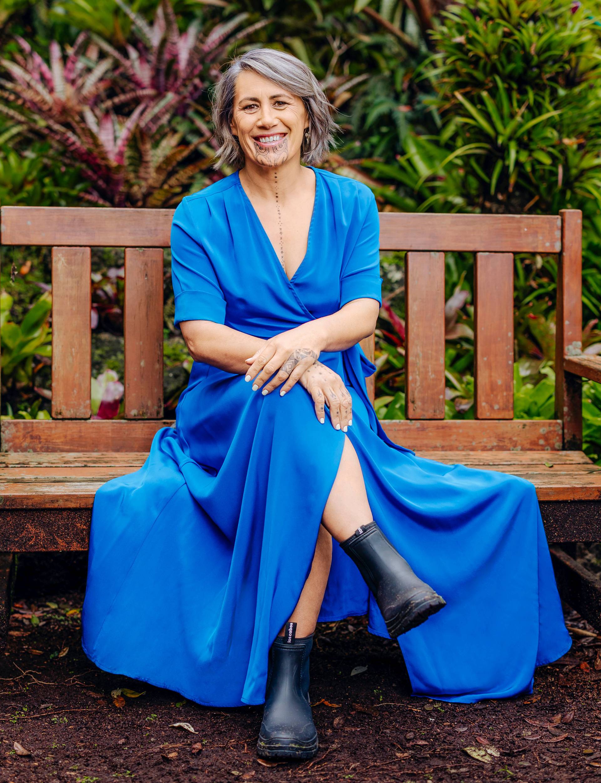 Jenny-May Clarkson sitting on an outdoor bench