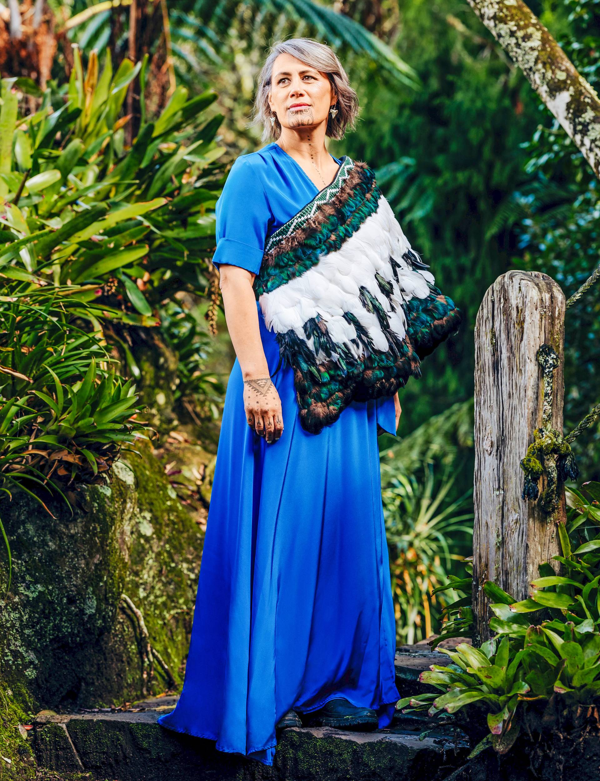 Jenny-May standing on a stone step in the bush