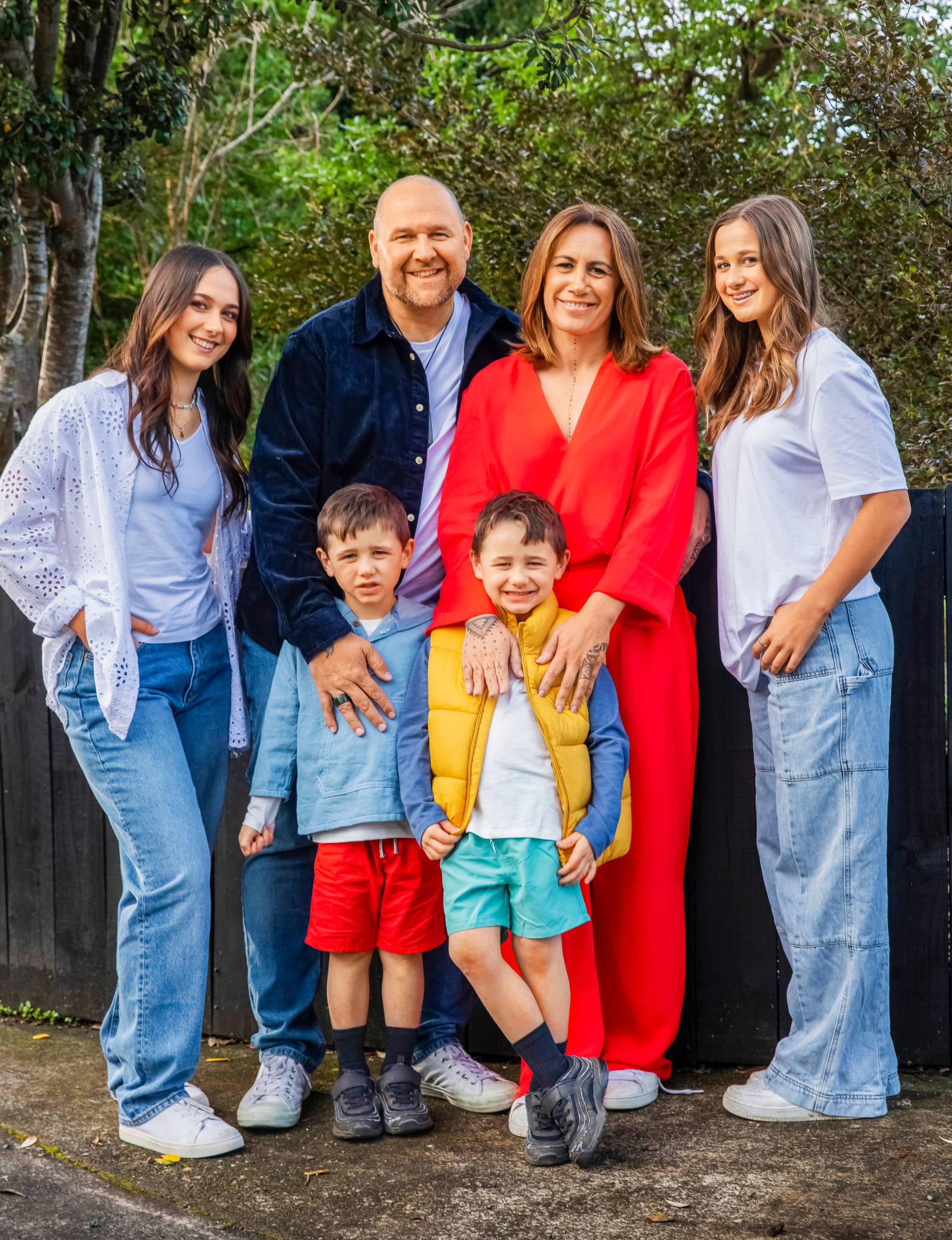 Jenny-May Clarkson standing with her kids and husband