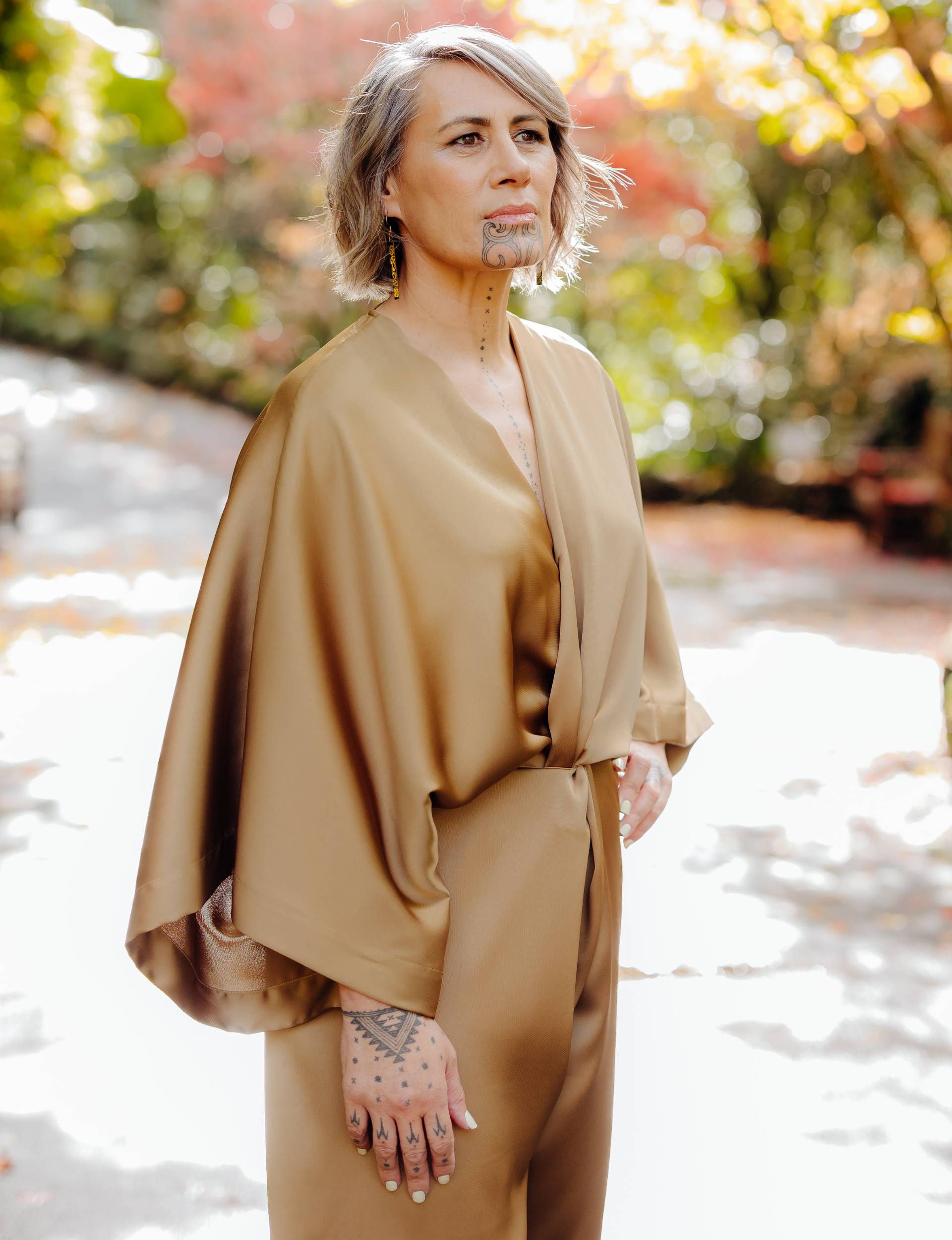 Jenny-May standing in a beige suit