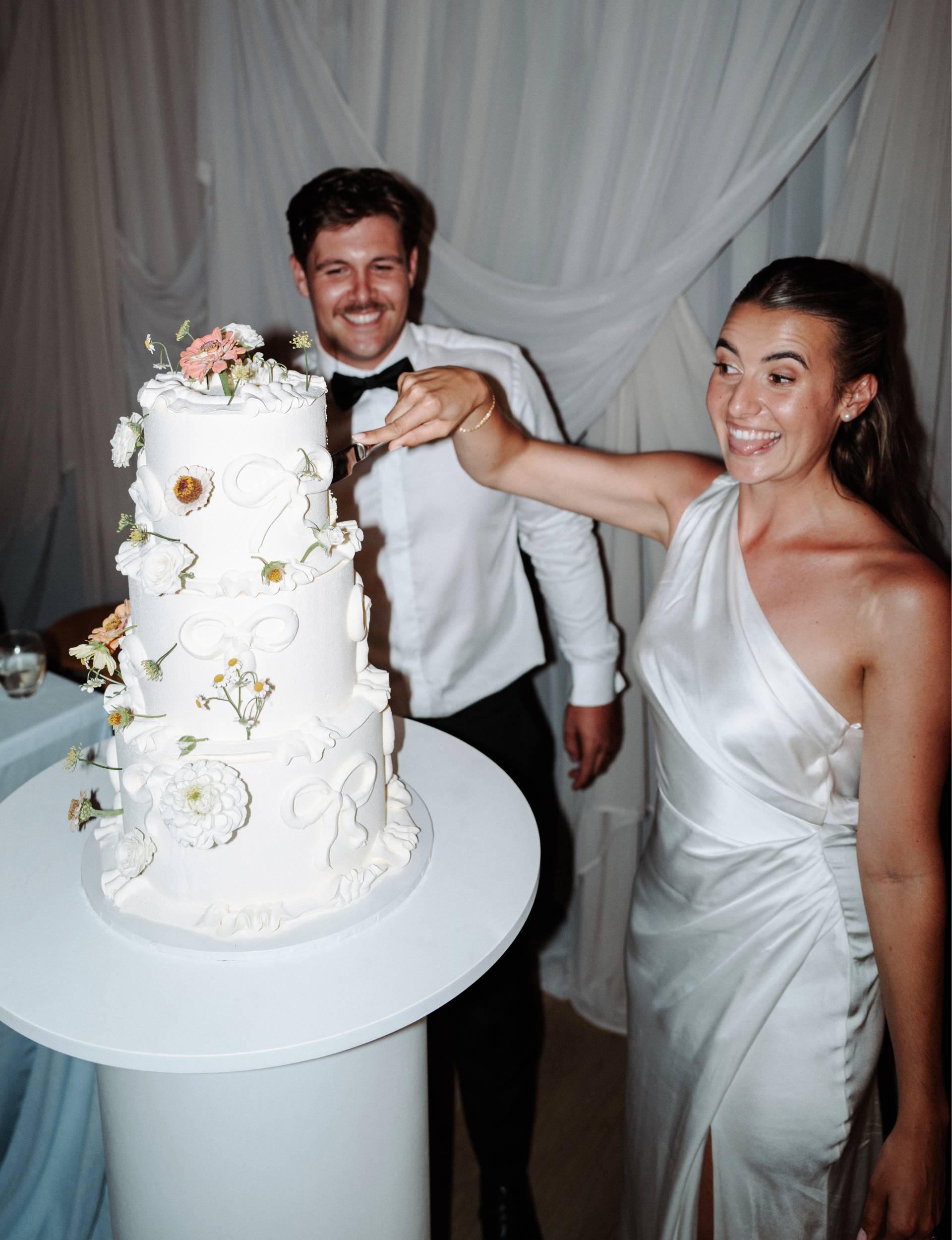 Healthy Kelsi cutting her wedding cake