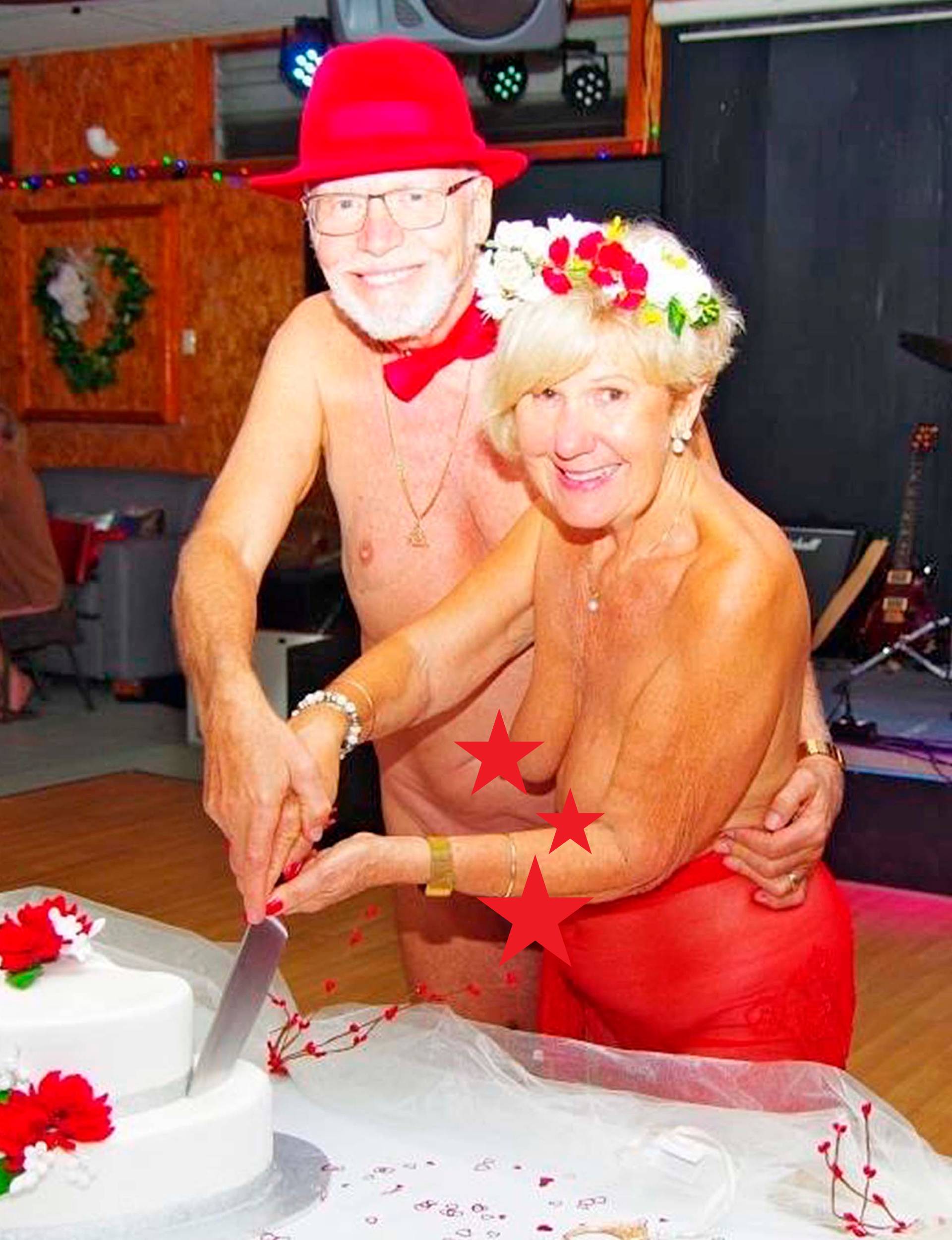 Debra and Tony cutting the cake at their nude wedding