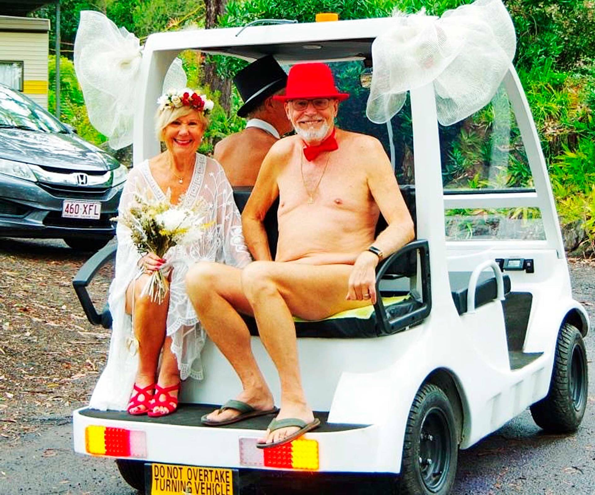 Debra and Tony going to their nude wedding on the back of a golf cart