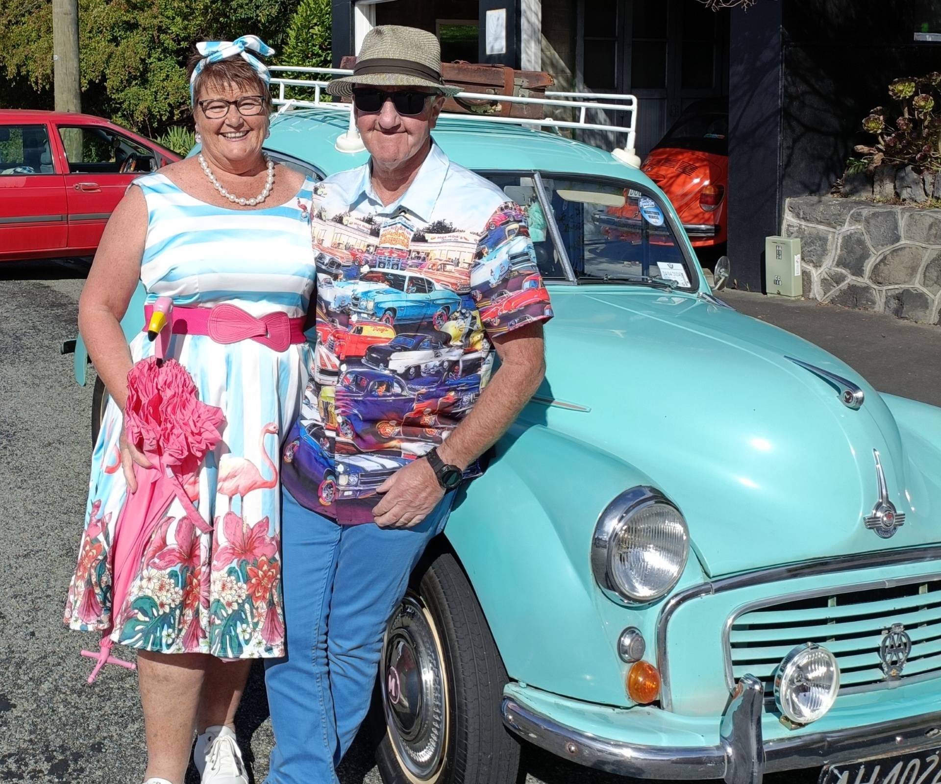 Anita and Brett leaning against the side of their Morris Minor