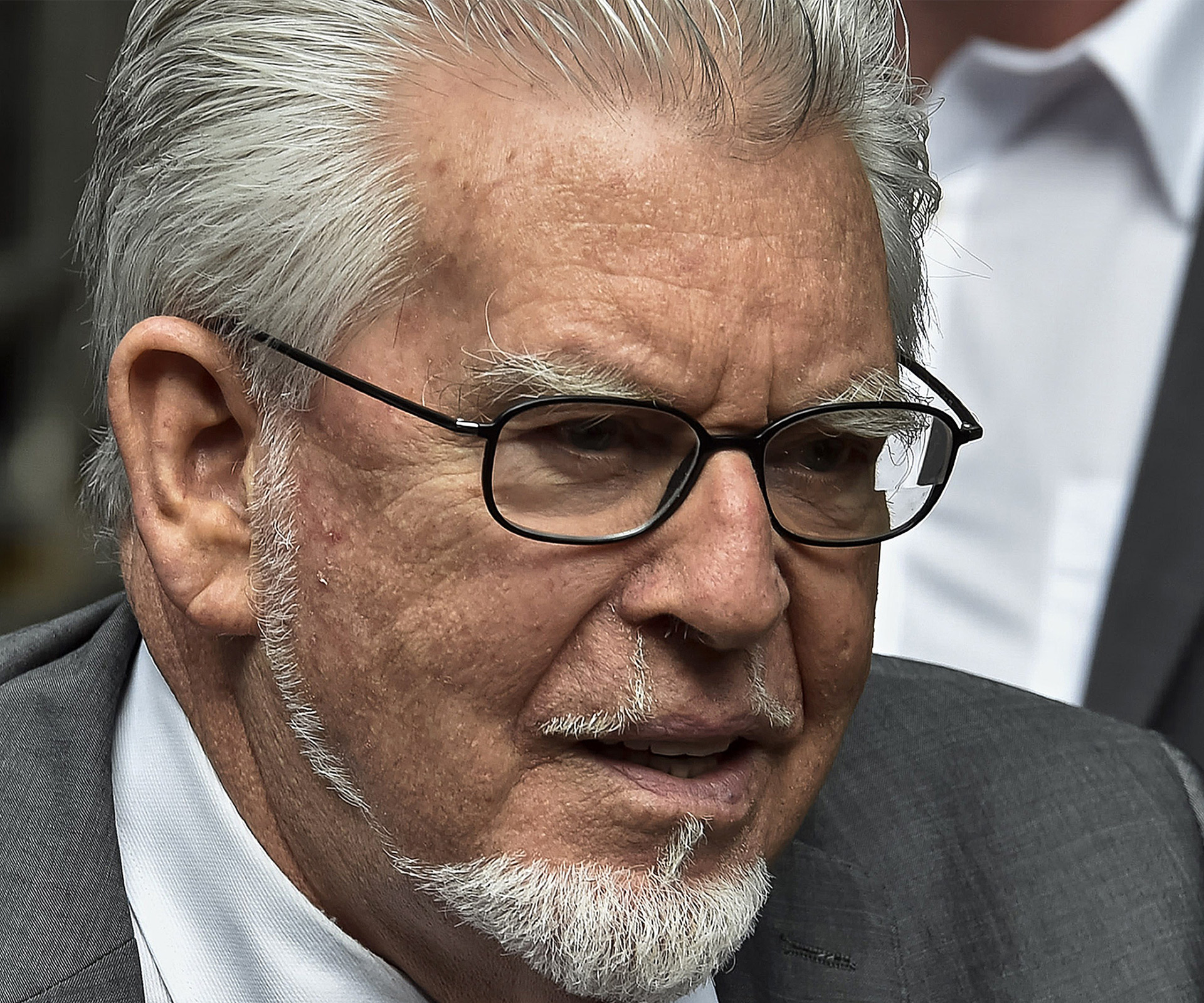 Rolf Harris has been released from prison on bail to face trial for indecent assault.