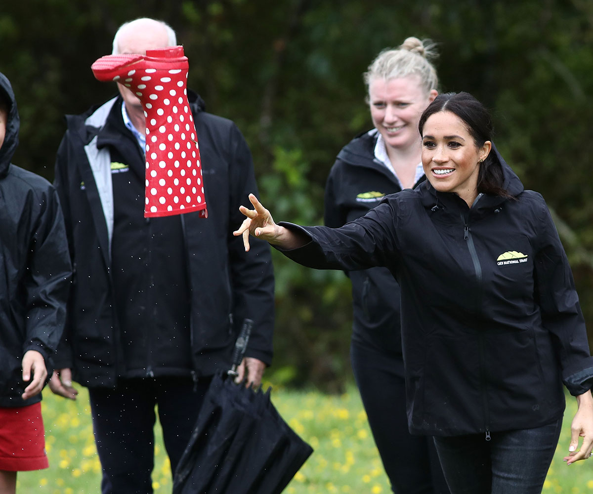 Duchess Meghan beats Prince Harry in a gumboot throwing competition at Redvale, Auckland
