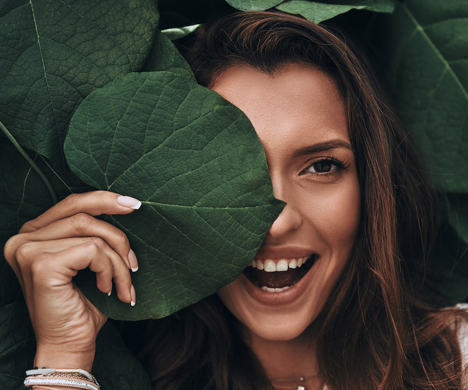 woman beauty shot behind leaf