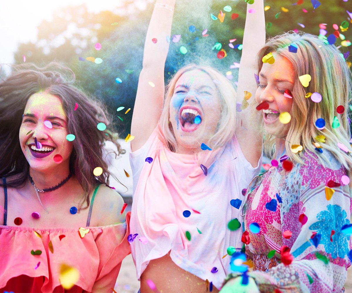 Group of three friends laughing confetti