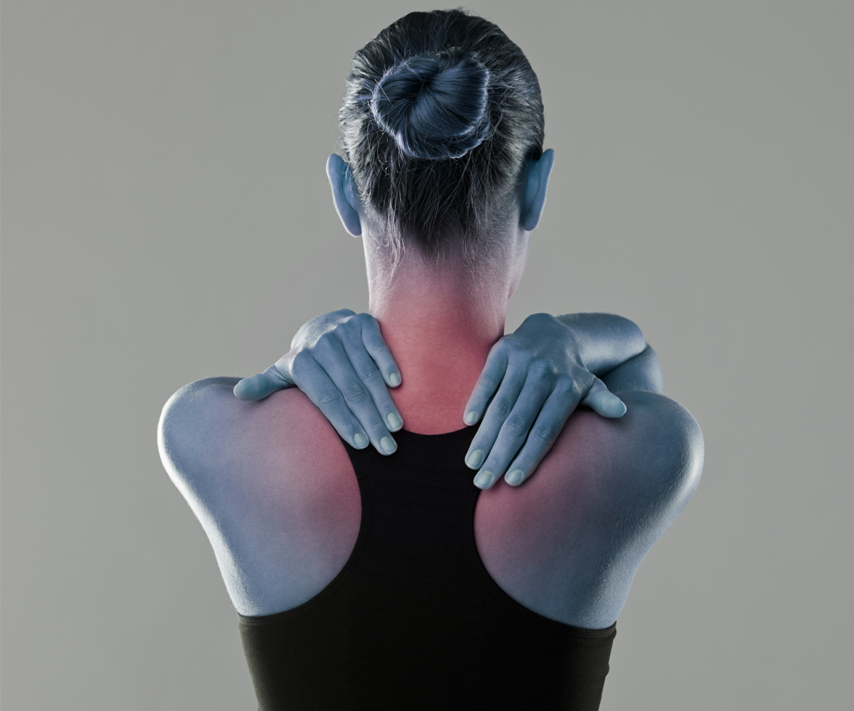 Woman rubbing inflamed neck pain