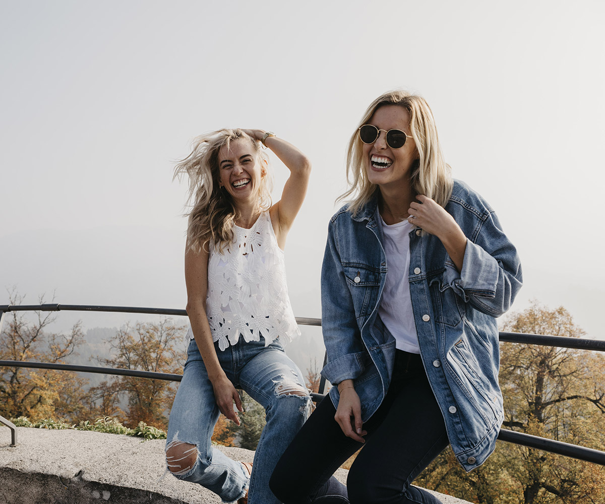 two women smiling in nature