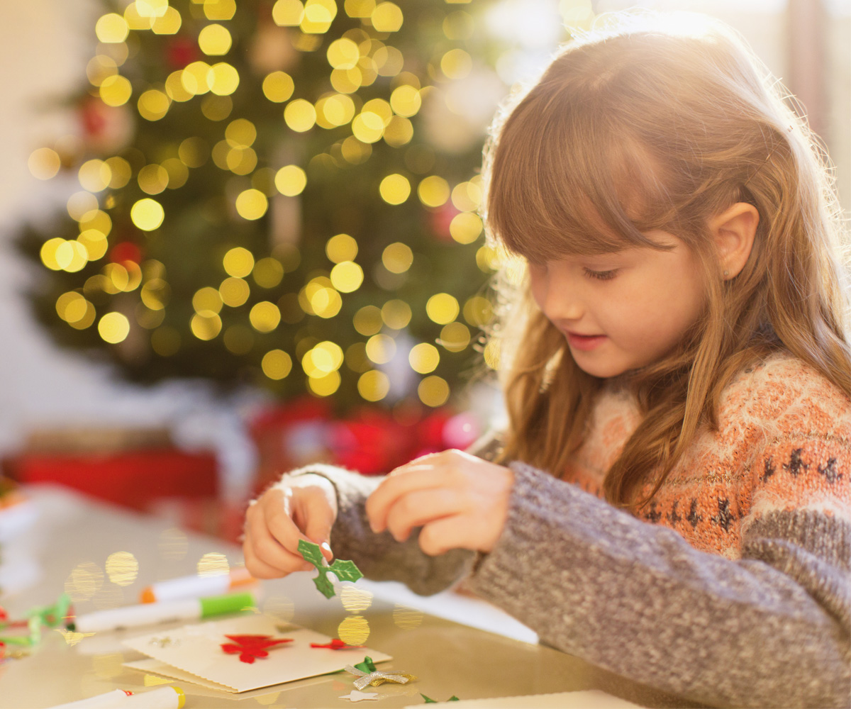 young girl doing Christmas crafts