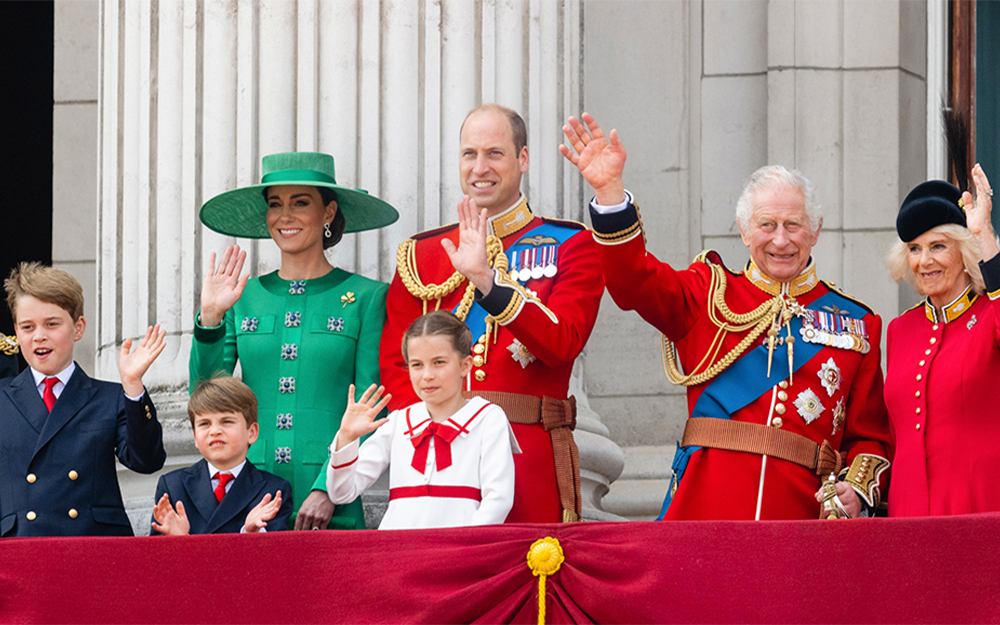 Prince George, Prince Louis, Princess Catherine, Prince William, Princess Charlotte, King Charles and Queen Camilla waving on the Buckingham Palace balcony