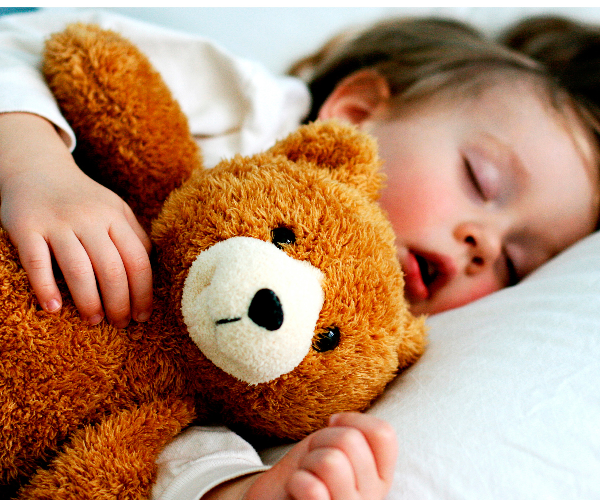 Child sleeping with teddy bear
