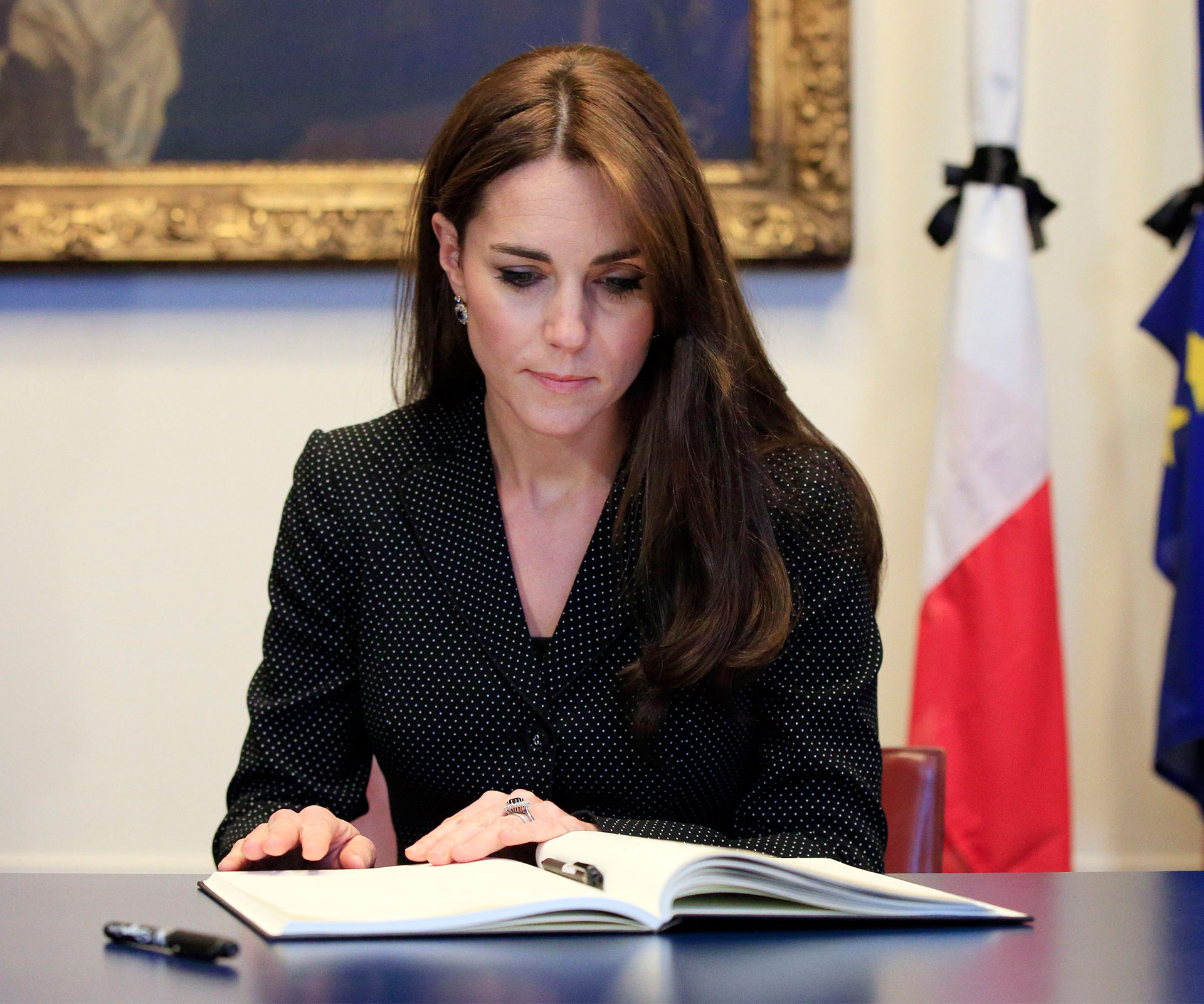 Duchess of Cambridge signs book of condolence.